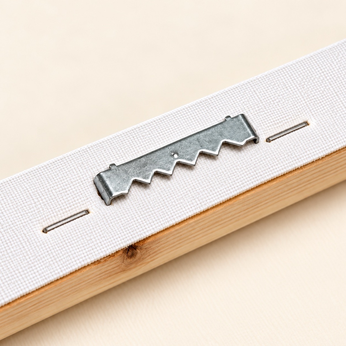 Close-up of canvas-wrapped wood frame and sawtooth hanging hardware
