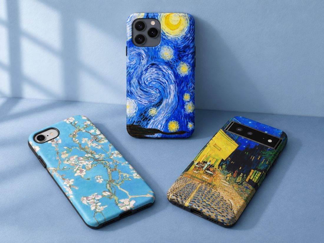 Van Gogh art phone case collection concept: Starry Night upright with Almond Blossom and Café Terrace at Night resting on a matte blue surface